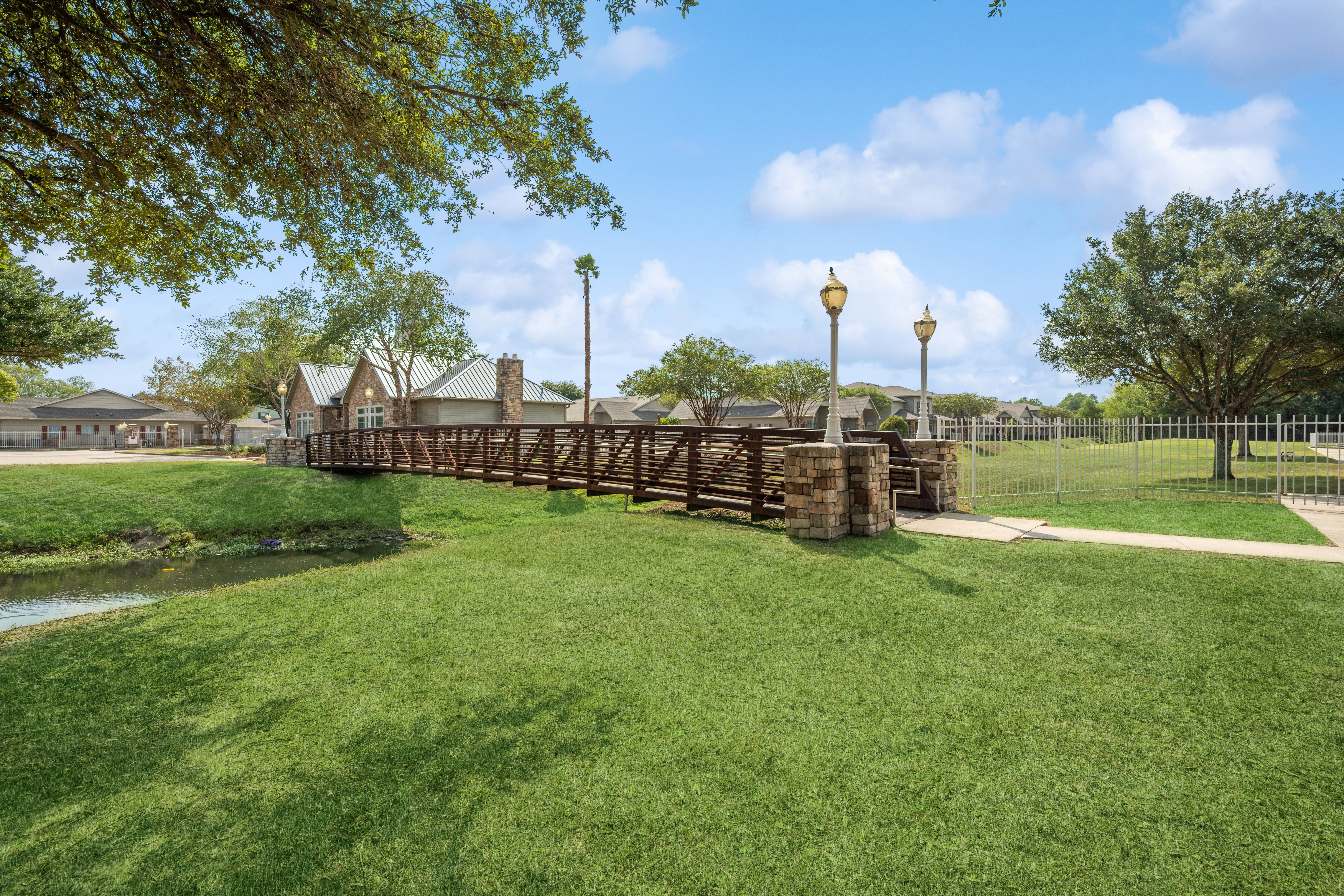 A wooden fence runs along a grassy area.